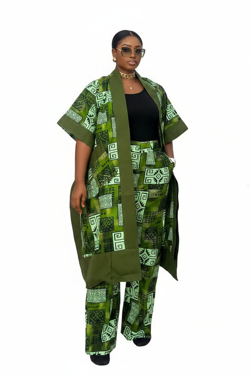 A person modeling a green and black patterned cotton kaftan jacket and matching trousers, shown in a video-style social media post with text overlays detailing the fabric and garment information.