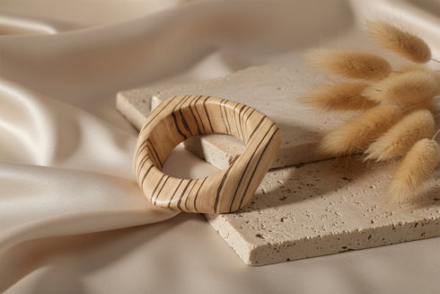 Wooden ring with zebra stripe pattern on a marble surface