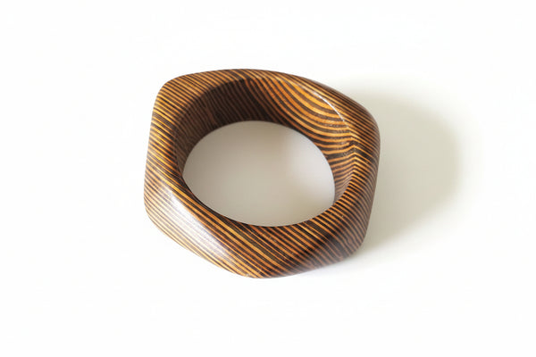 Wooden ring with a marble center on a marble surface
