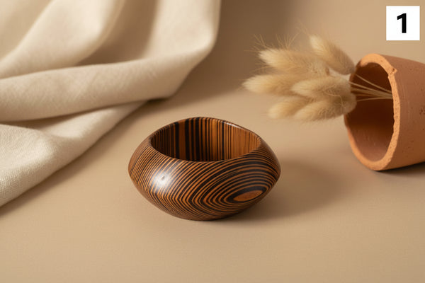 Wooden ring with striped pattern on a marble surface
