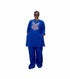 A person wearing a royal blue traditional outfit with a purple butterfly embroidery on the chest, standing in front of a black slatted wall. The image is a mobile screenshot with text overlays showing a price and WhatsApp contact, along with social media interaction icons.