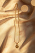 Gold necklace on a marble surface