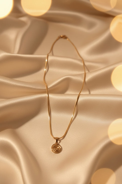 Gold necklace on a marble surface
