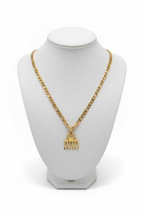 Gold chain necklace with a unique pendant on a marble surface