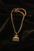 Gold chain with a decorative clasp on a marble surface