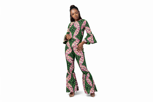 Woman wearing a green and pink patterned jumpsuit on a white background