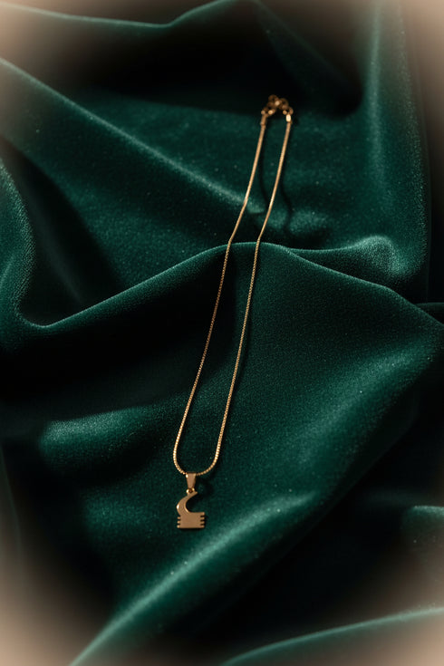 Gold necklace on a marble surface