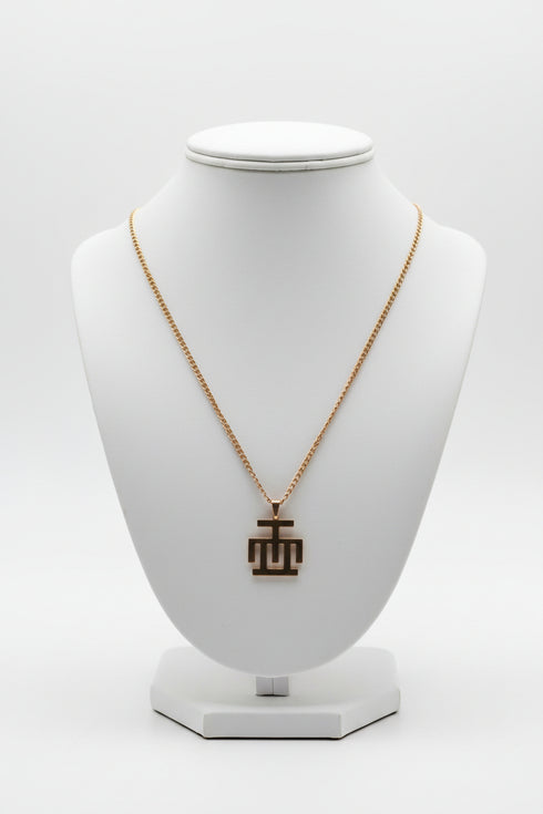 Gold necklace on a marble surface