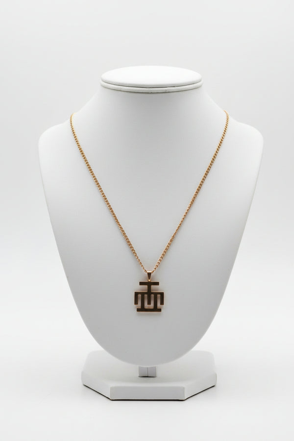 Gold necklace on a marble surface