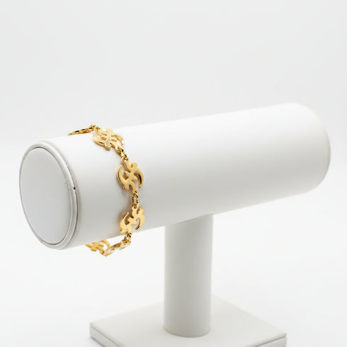 Gold bracelet on a marble surface