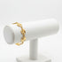 Gold bracelet on a marble surface