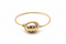 Gold bracelet with a unique design on a white background