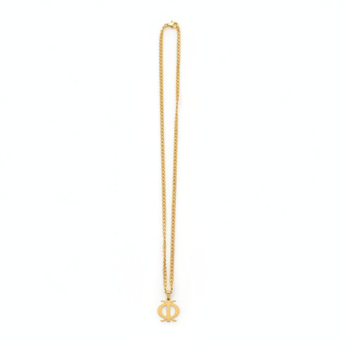 Gold chain with a decorative clasp on a marble surface