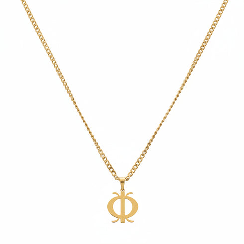 Gold necklace with a unique pendant on a marble surface