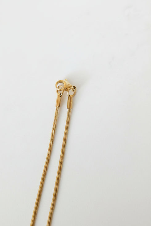 Gold hairpin on a marble surface