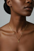 Gold necklace on a marble surface