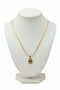 Gold necklace with a decorative clasp on a marble surface