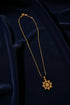 Gold necklace with a pendant on a white mannequin bust against a white background