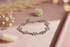 Silver bracelet on a pink surface with dried flowers