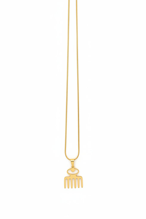Metallic necklace with a decorative end on a marble surface