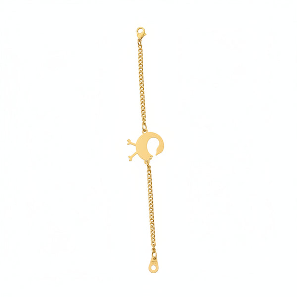 Gold bracelet with a unique clasp on a marble surface