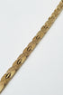 Gold chain bracelet on a marble surface