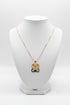 Gold necklace with a decorative clasp on a marble surface