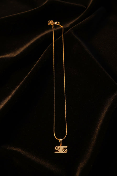 Gold necklace on a marble surface