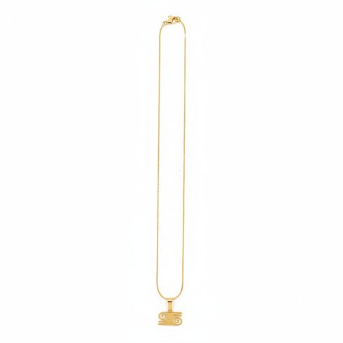 Gold necklace on a marble surface