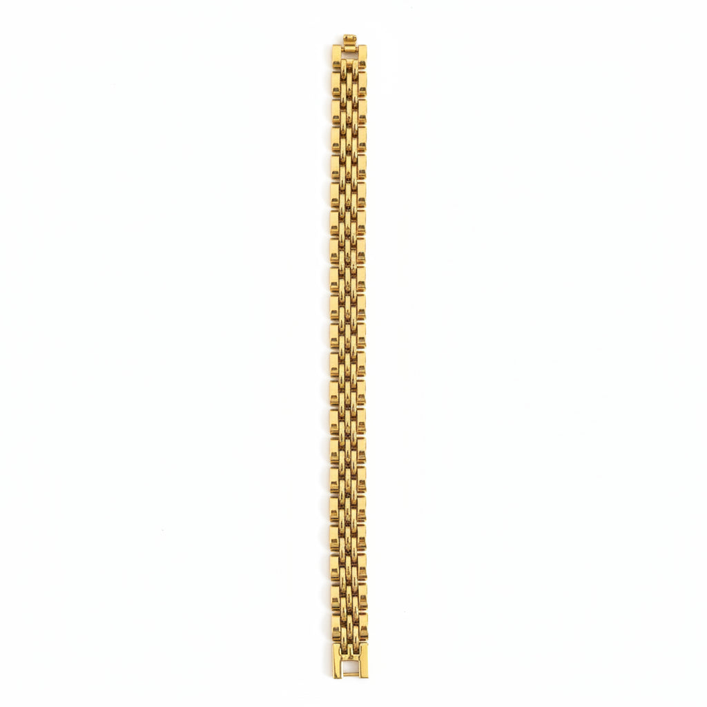 Gold bracelet on a marble surface