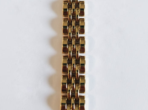 Gold bracelet on a marble surface