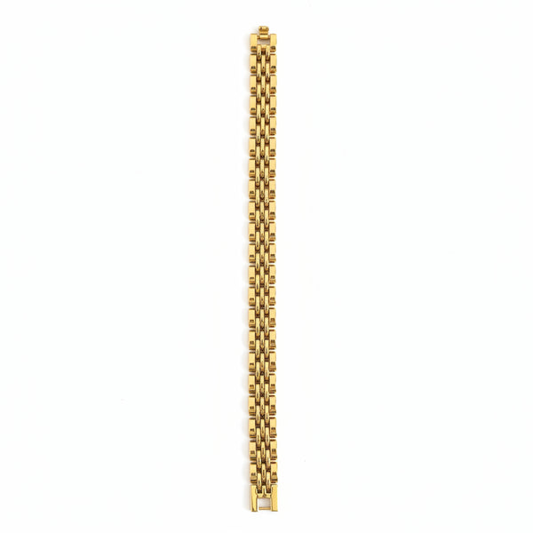 Gold bracelet on a marble surface