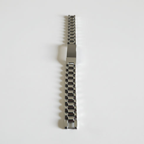 Metallic watch strap on a marble surface
