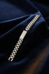 Metallic watch strap on a marble surface
