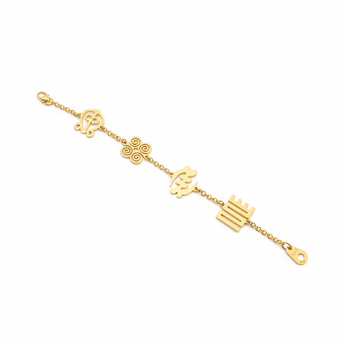 Gold bracelet with floral and leaf designs on a marble surface