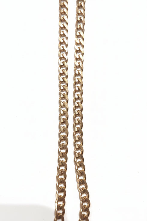 Gold chain on a marble surface