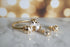 Gold and pearl ring on a marble surface
