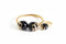 Gold and black beaded earring on a marble background