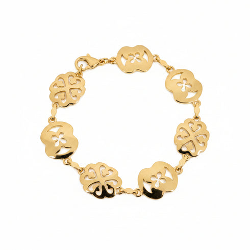 Gold bracelet with floral designs on a marble surface