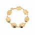 Gold bracelet with floral designs on a marble surface