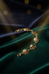 Gold bracelet on a marble surface