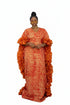A woman modeling a vibrant orange and red patterned crepe maxi dress with a high waist, shown in a social media post with text overlays and a dark striped background.