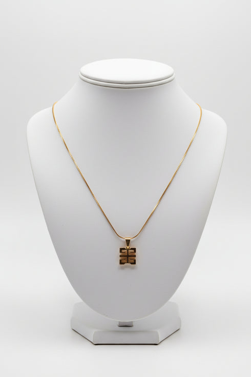 Gold necklace on a marble surface