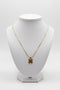 Gold necklace on a marble surface