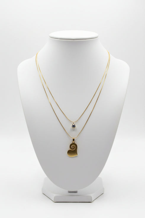 Necklace with a heart-shaped pendant on a marble surface