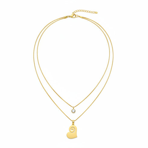 Gold necklace with a heart-shaped pendant on a white background