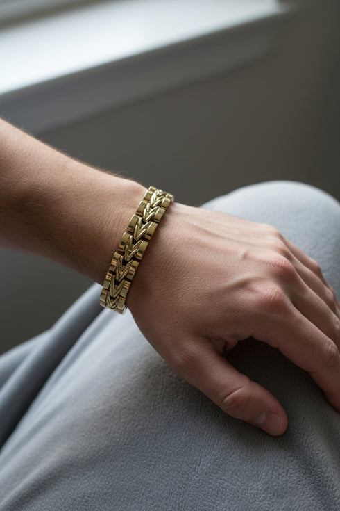 Gold bracelet on a marble surface
