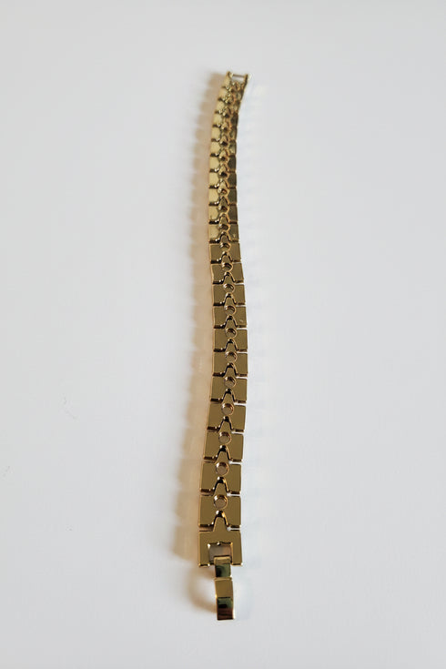Gold bracelet on a marble surface