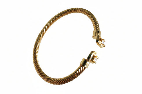 Gold hoop earrings on a marble background