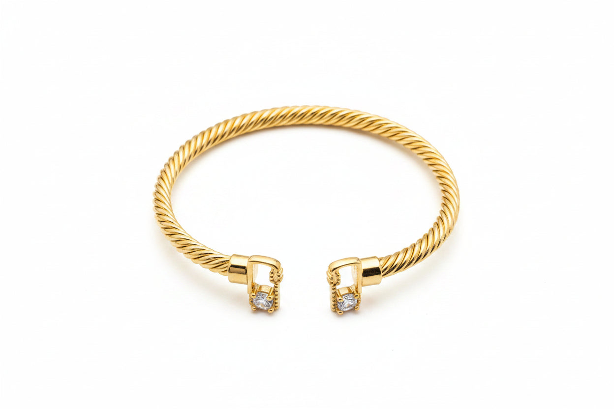 Gold bracelet with diamond accents on a marble surface